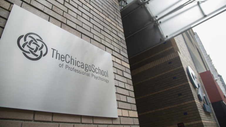 entrance to a building with the chicago school plaque