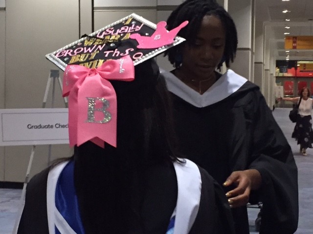 woman with decorated grad cap in pink