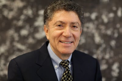 man with curly hair wearing a suit