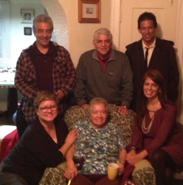 older woman in chair surrounded by people