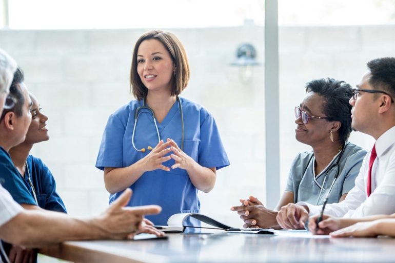 woman in blue scrubs and stethoscope