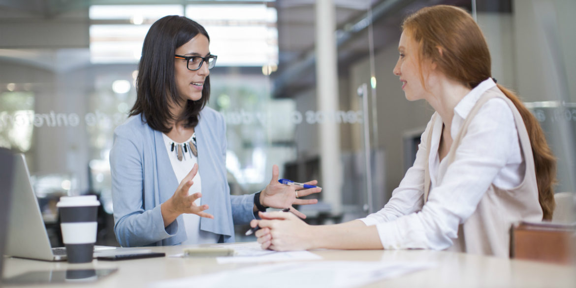 two women talking in office