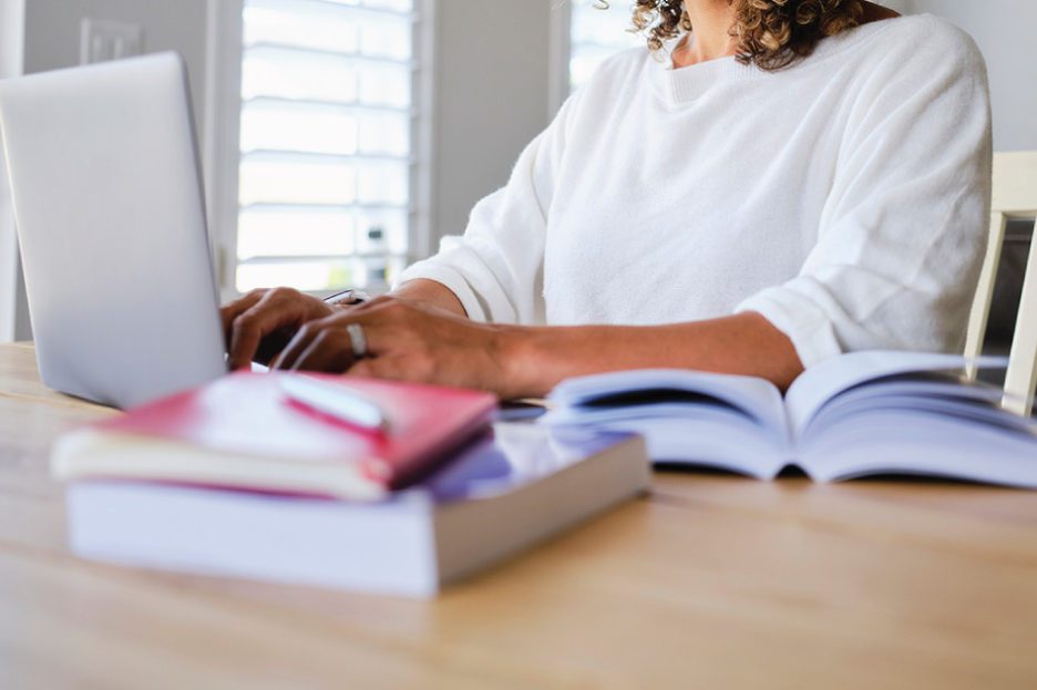Woman typing on laptop computer