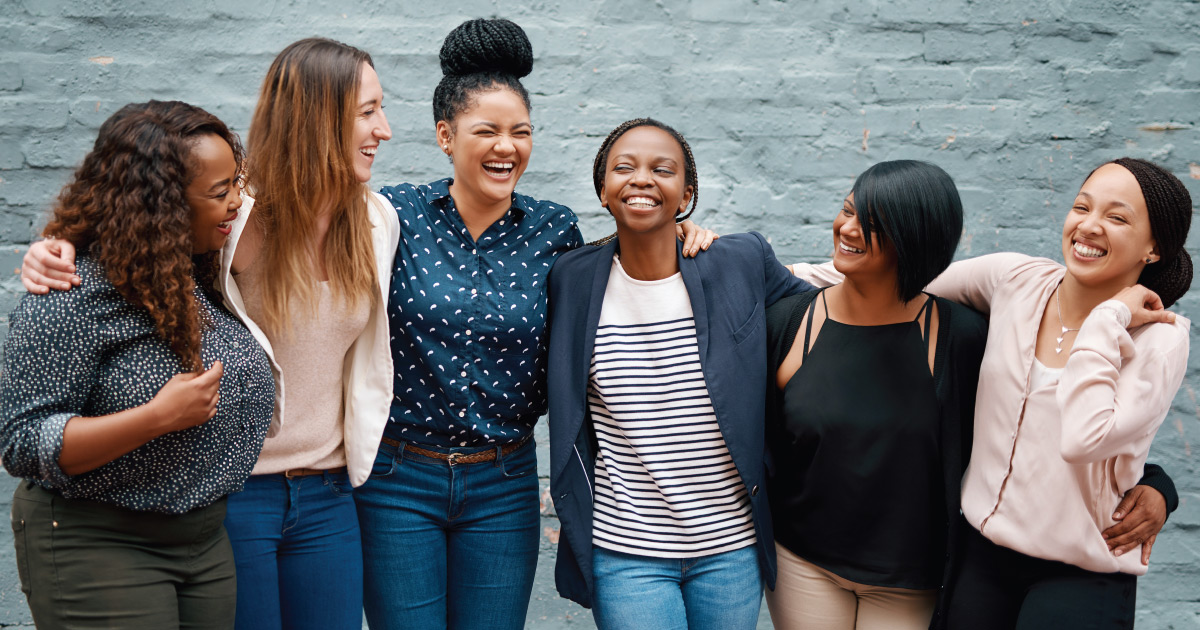 Six young women laughing together