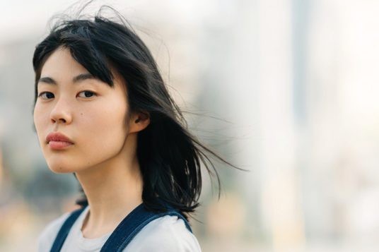 Woman looks into camera with blurred background