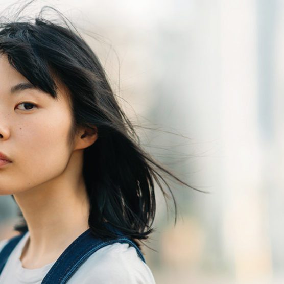 Woman looks into camera with blurred background