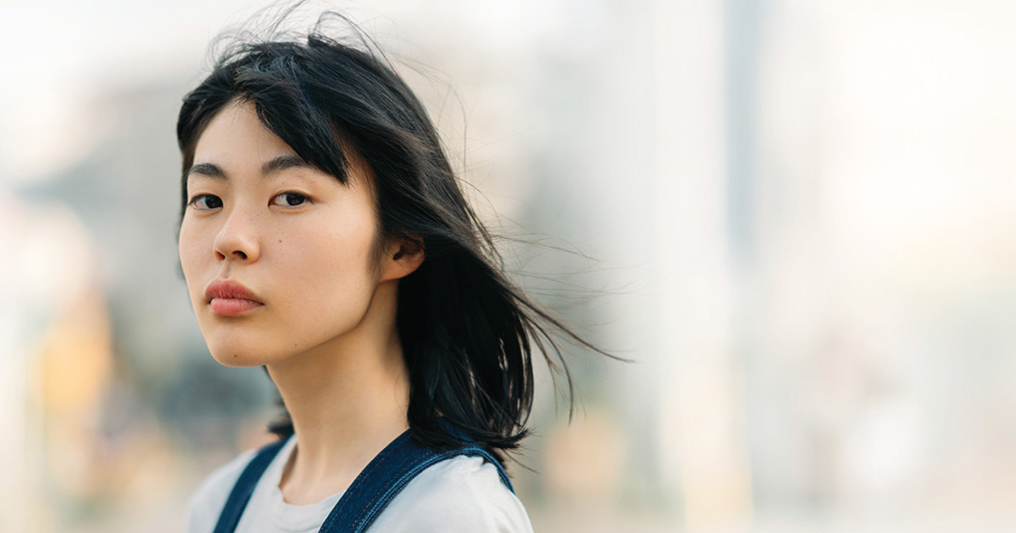 Woman looks into camera with blurred background
