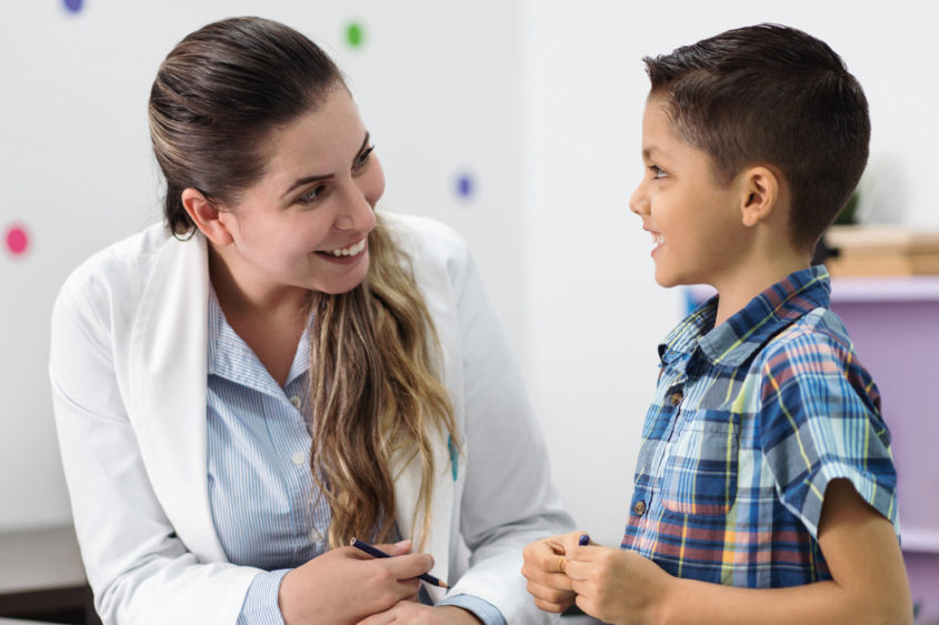 Image of a doctor working with a child.