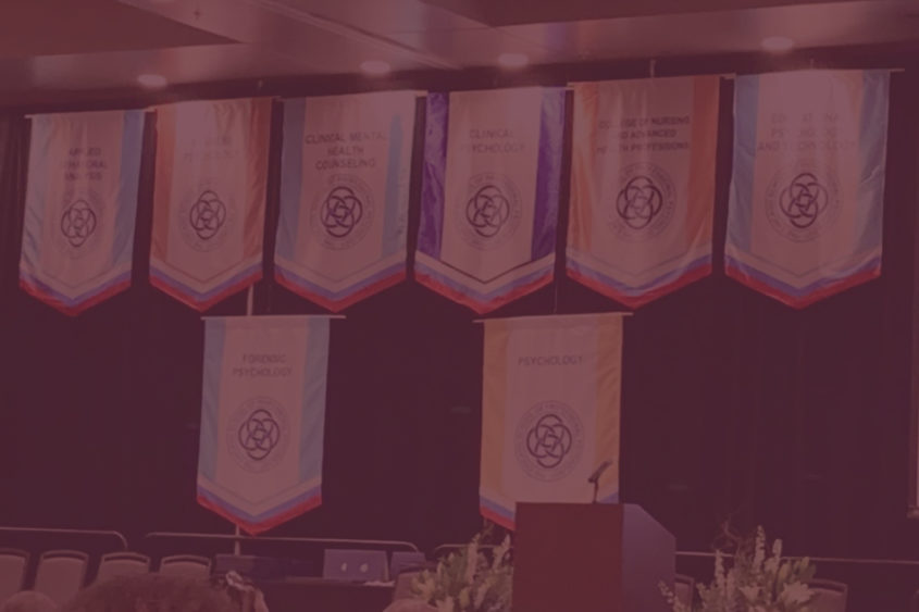 Photo of the commencement stage at The Chicago School's Dallas campus commencement.