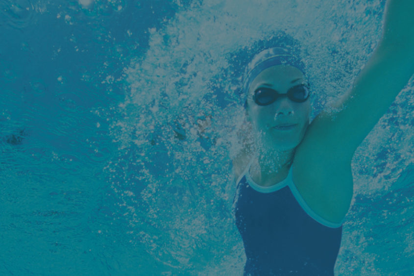 Photo of a woman swimming in a pool.