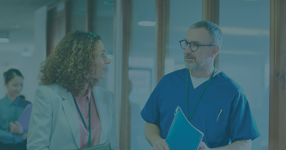 Photo of two medical professionals talking.