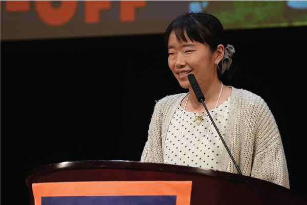 Photo of Emily Her speaking at the 2022 NRCI conference, It’s Tough Enough: Adolescent Mental Health in Our Changing World.