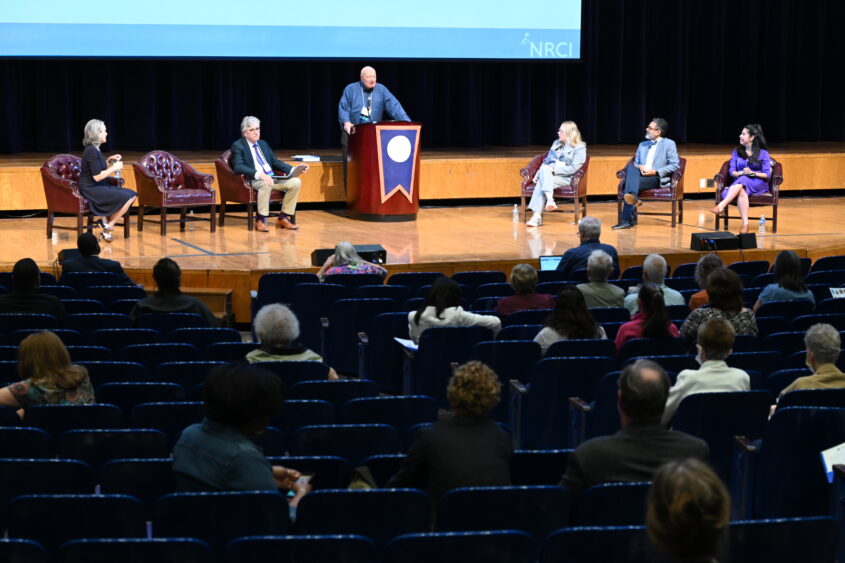 Wide view of stage and audience in auditorium