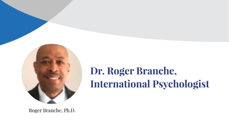 Dr. Roger Branche smiles at the camera in a photograph inset on a banner displaying his name.