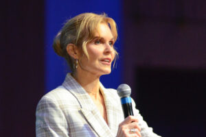 Jennifer Arrington speaking with microphone