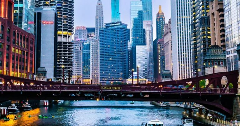 Chicago's skyline looms over its river.