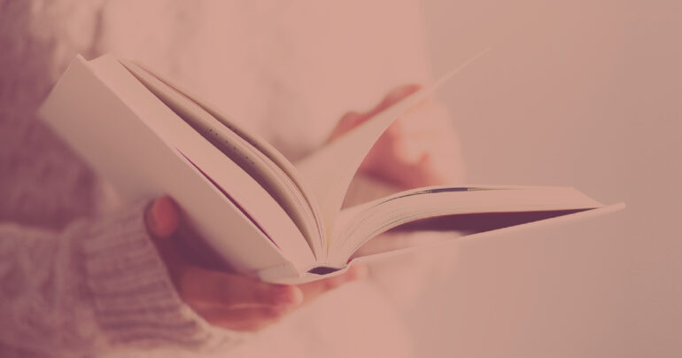 person holding a book with open pages