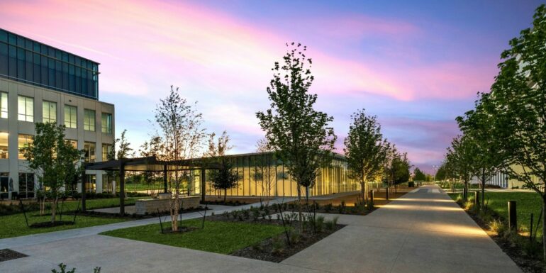 The Chicago School's Dallas campus appears before a pink-and-purple sunset.