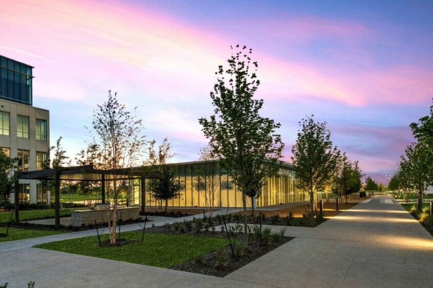 The Chicago School's Dallas campus appears before a pink-and-purple sunset.