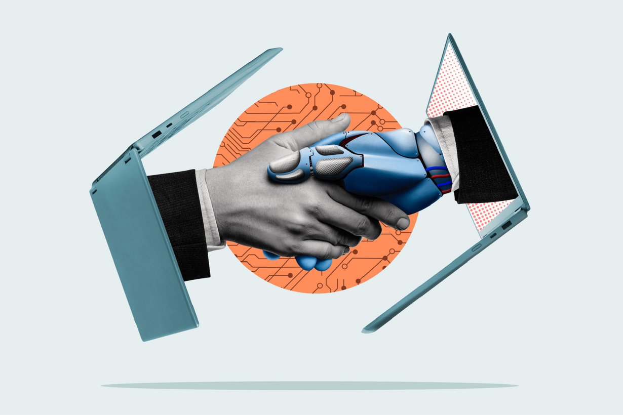 Two hands, one human and one robotic, each emerge from a laptop computer to shake each other.