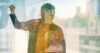 A silhouette of a teacher is overlaid on a background that shows global environments.