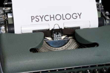 A manual typewriter with the piece of paper in it with the word psychology on it.
