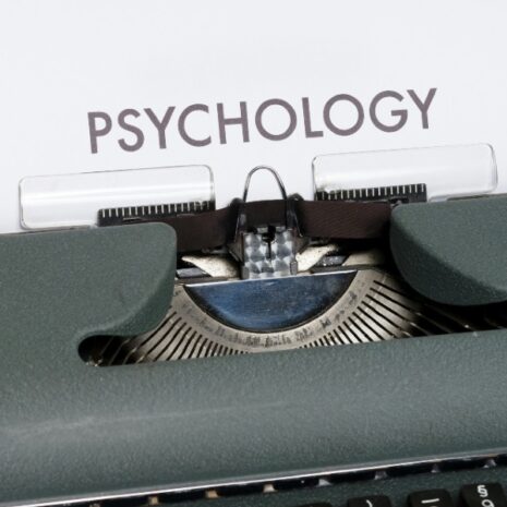 A manual typewriter with the piece of paper in it with the word psychology on it.