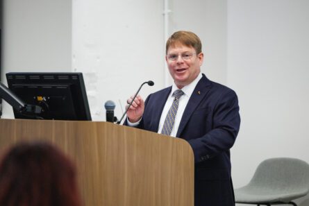 Dr. Kevin O'Connor speaking from podium.