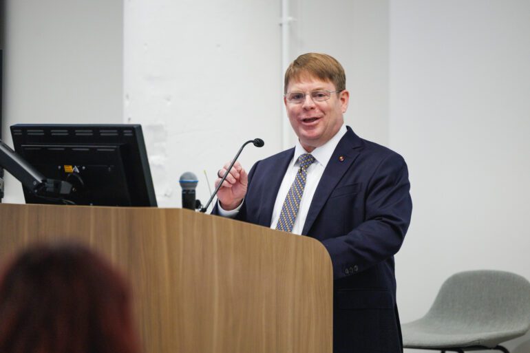 Dr. Kevin O'Connor speaking from podium.