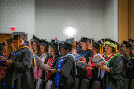 photo of graduates reciting a pledge