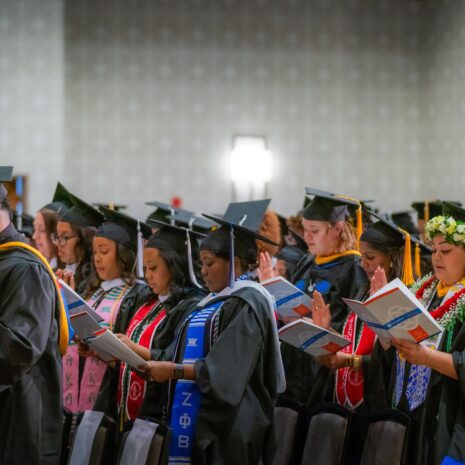 photo of graduates reciting a pledge