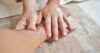 Occupational therapist using hands-on therapy techniques on a patient's wrist and hand.