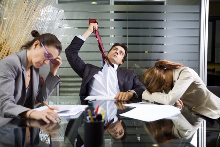 group of people looking exhausted at office