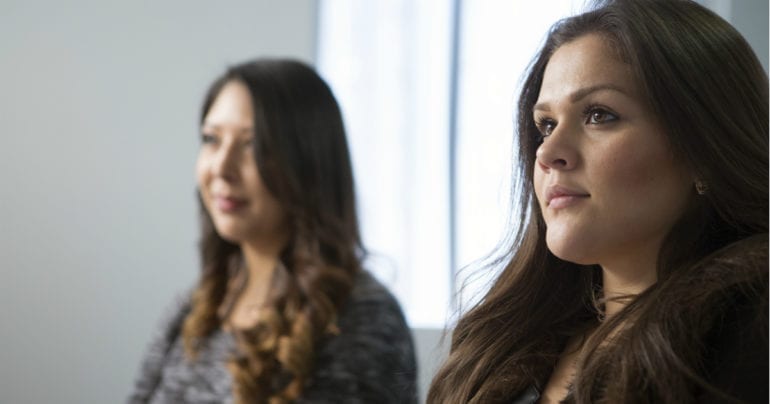 two women listening intently