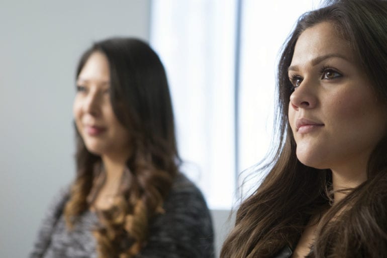 two women listening intently