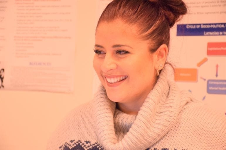 woman smiling in white sweater