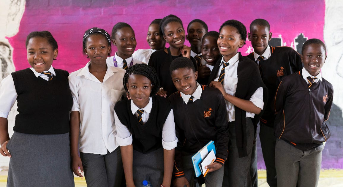 students posing against colorful background