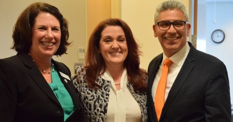 three people smiling