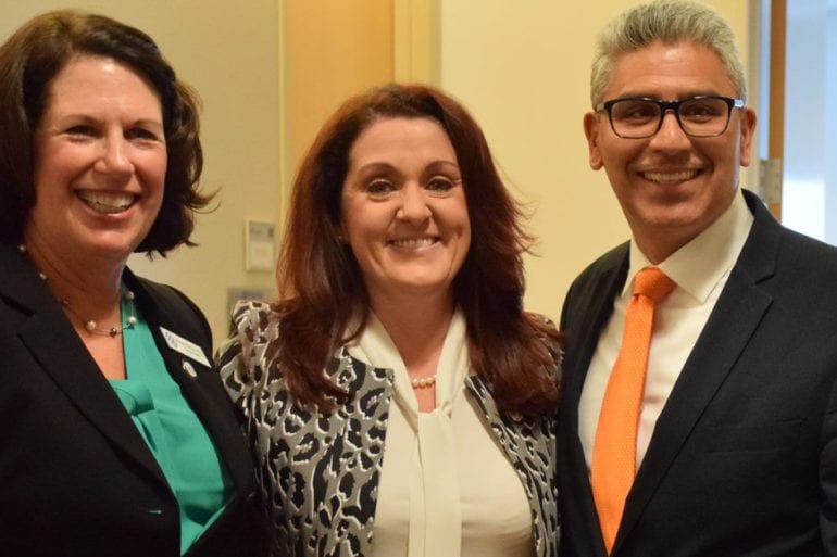 three people smiling