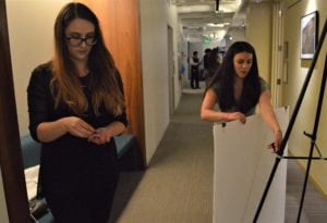 two women setting up a presentation