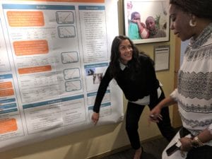 woman pointing to chart on wall