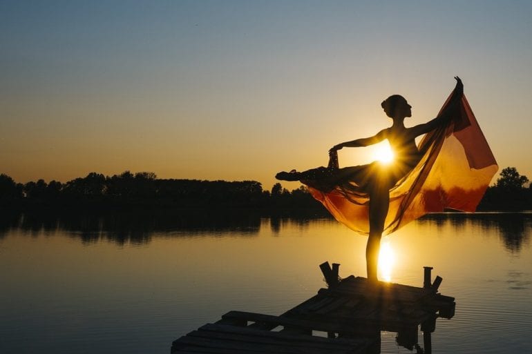 woman balancing on pier