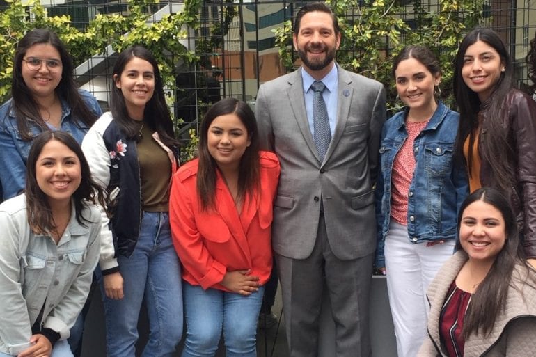 man standing with a group of women
