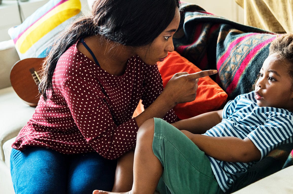 mother pointing menacingly at child