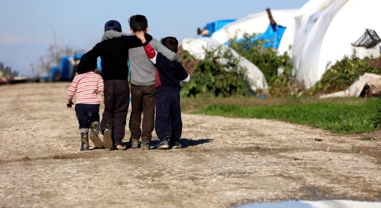 four young children walking