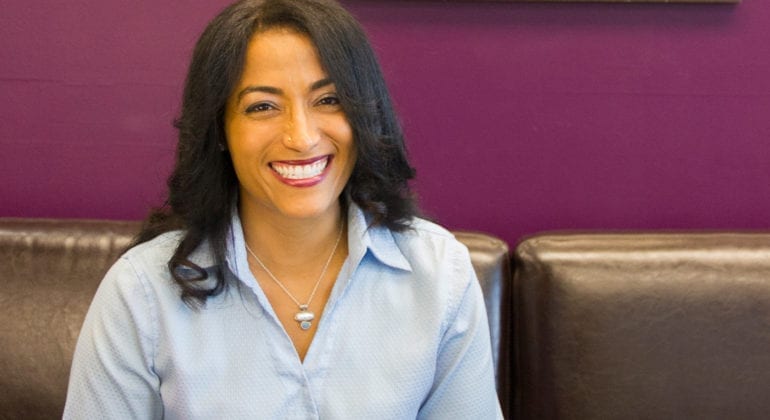woman in blue shirt smiling