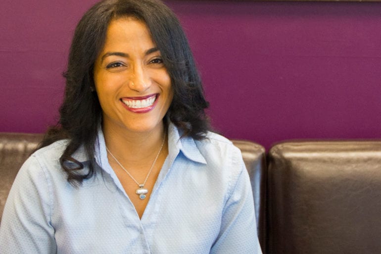 woman in blue shirt smiling