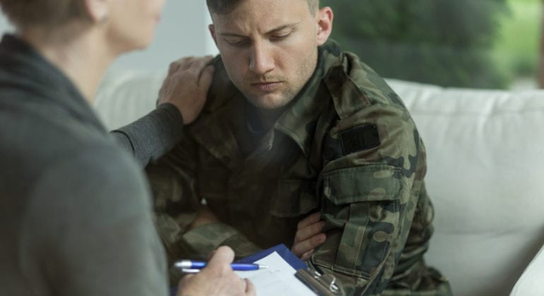 man in military fatigues with therapist