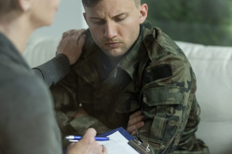 man in military fatigues with therapist