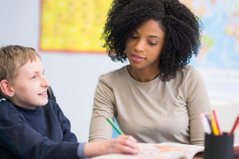 woman helping child with special needs